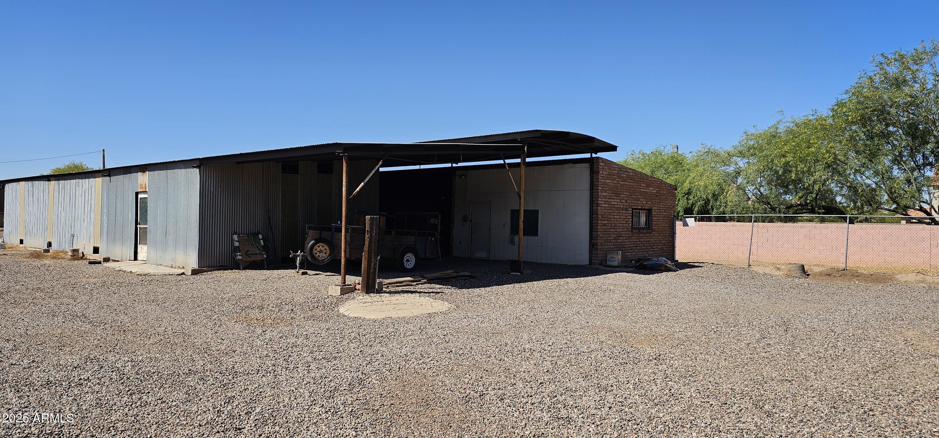 129 South 1st Street Buckeye, AZ 85326 - Photo 3 of 16 a view of a house with backyard and trees