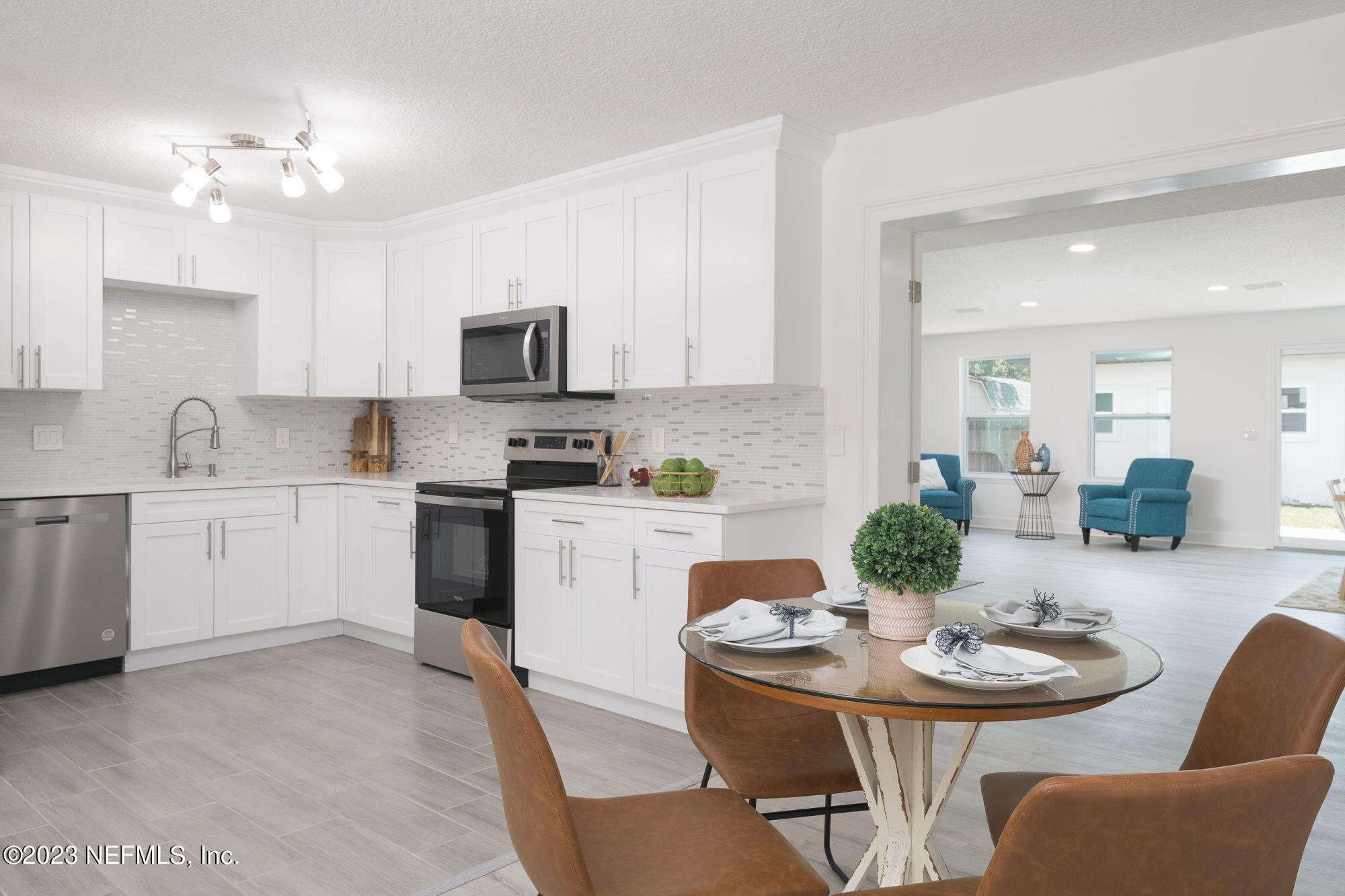 425 Penman Road Neptune Beach, FL 32266 - Photo 5 of 19 a kitchen with a white center island and cabinets