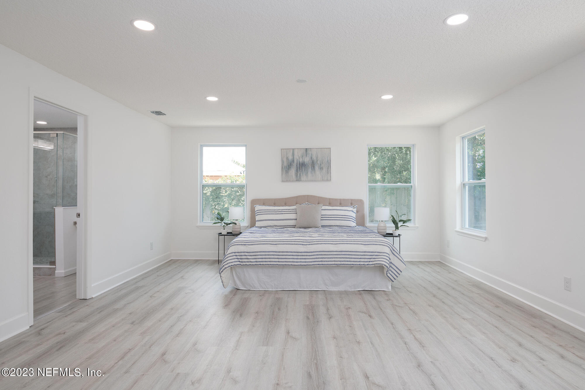 425 Penman Road Neptune Beach, FL 32266 - Photo 8 of 19 a spacious bedroom with a bed and a large window
