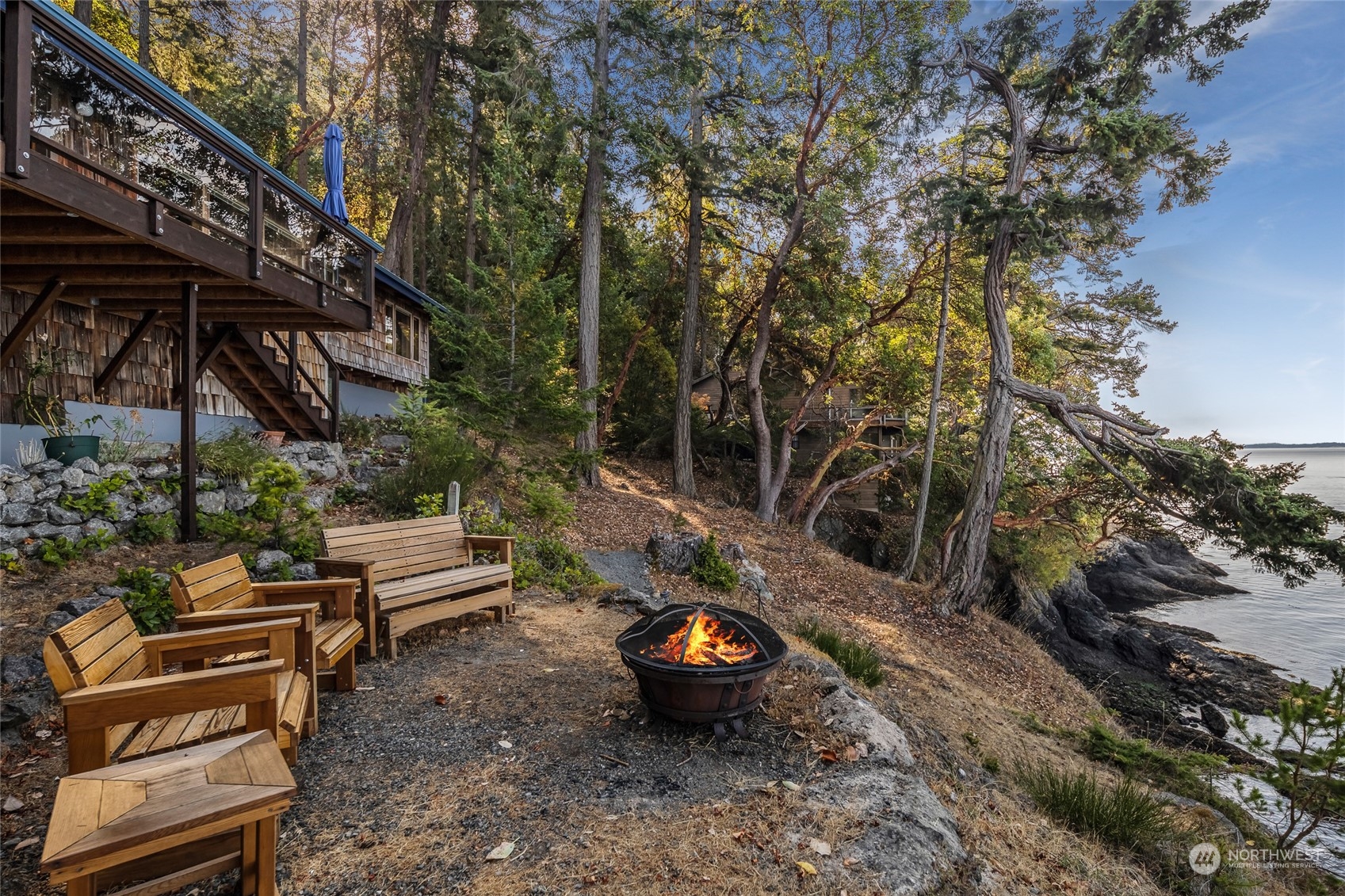 449 Madrona Drive San Juan Island, WA 98250 - Photo 19 of 27 a backyard of a house with barbeque oven table and chairs