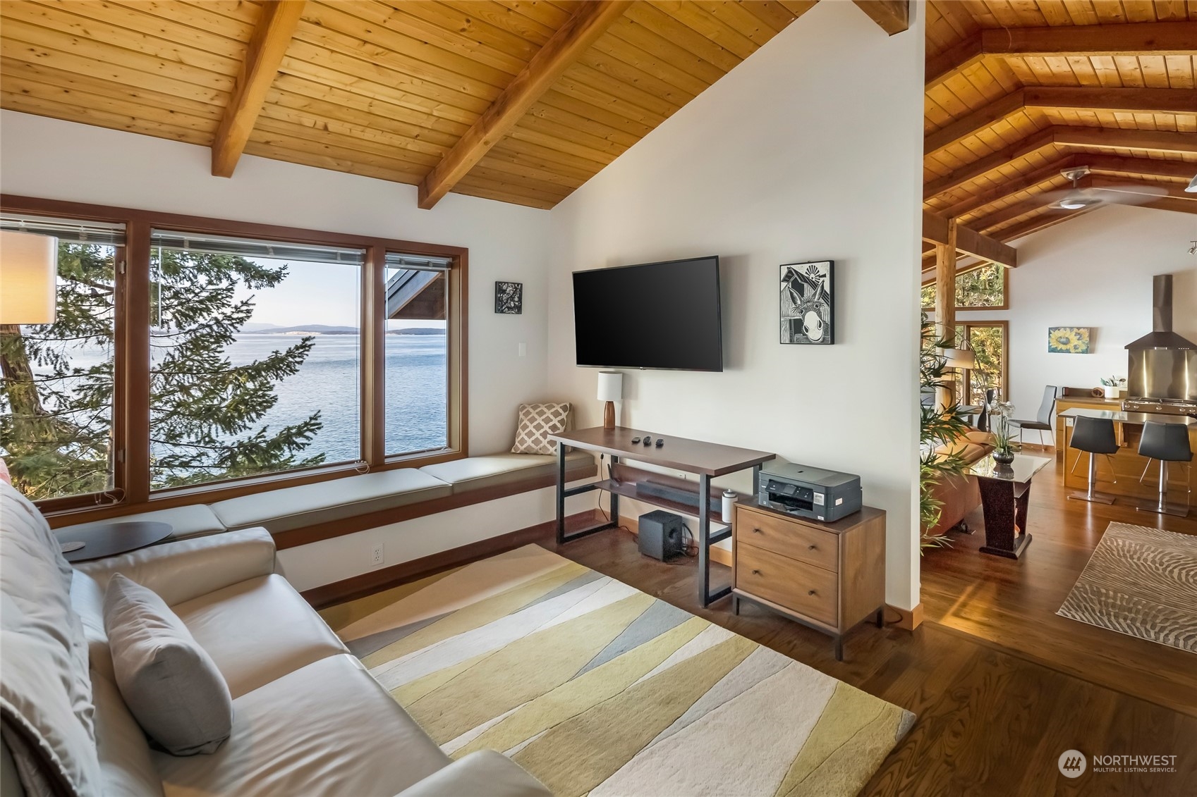 449 Madrona Drive San Juan Island, WA 98250 - Photo 21 of 27 a living room with furniture a flat screen tv and a floor to ceiling window