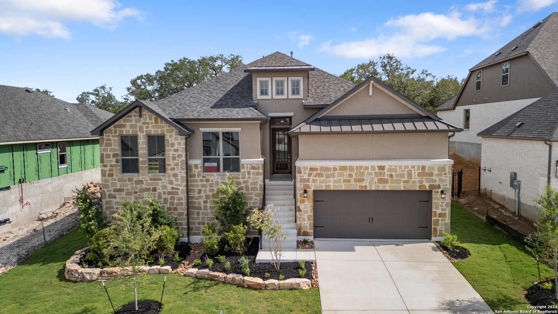 a front view of a house with a garden