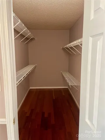 wooden floor with fireplace and windows