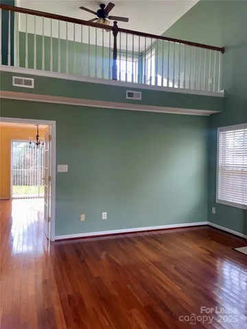 a kitchen with stainless steel appliances granite countertop a stove a sink dishwasher and a refrigerator with wooden floor