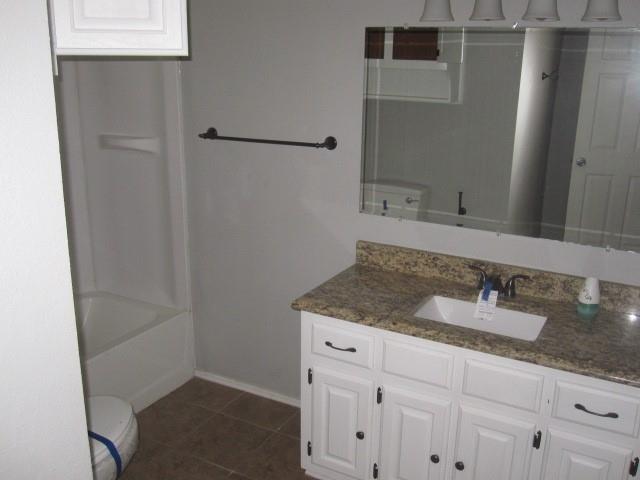 2801 Pyramid Circle Denison, TX 75020 - Photo 16 of 18 a bathroom with a granite countertop sink and mirror