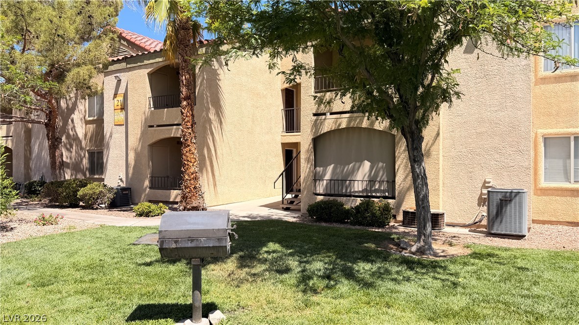 7885 West Flamingo Road, Unit 1131 Las Vegas, NV 89147 - Photo 35 of 36 A well-maintained apartment complex features inviting balconies and green common areas.