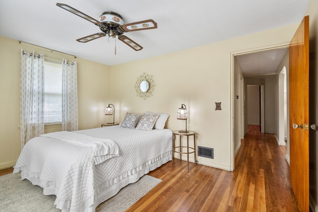 5 Gerry Road Lynnfield, MA 01940 - Photo 13 of 22 a bedroom with a bed and a chandelier