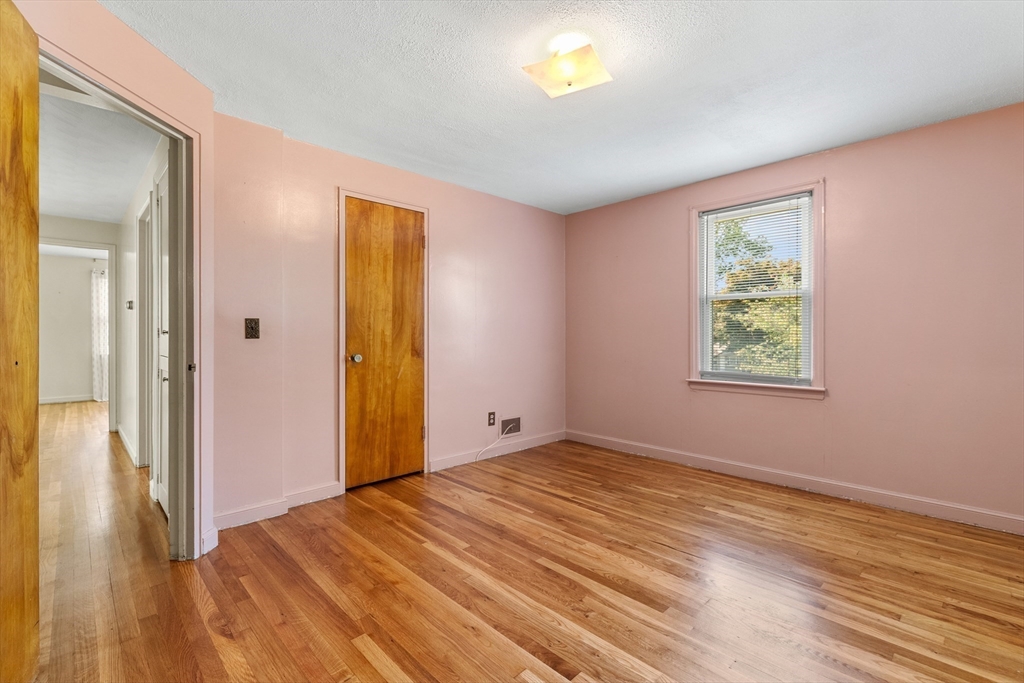 5 Gerry Road Lynnfield, MA 01940 - Photo 15 of 22 a view of an empty room with window and wooden floor