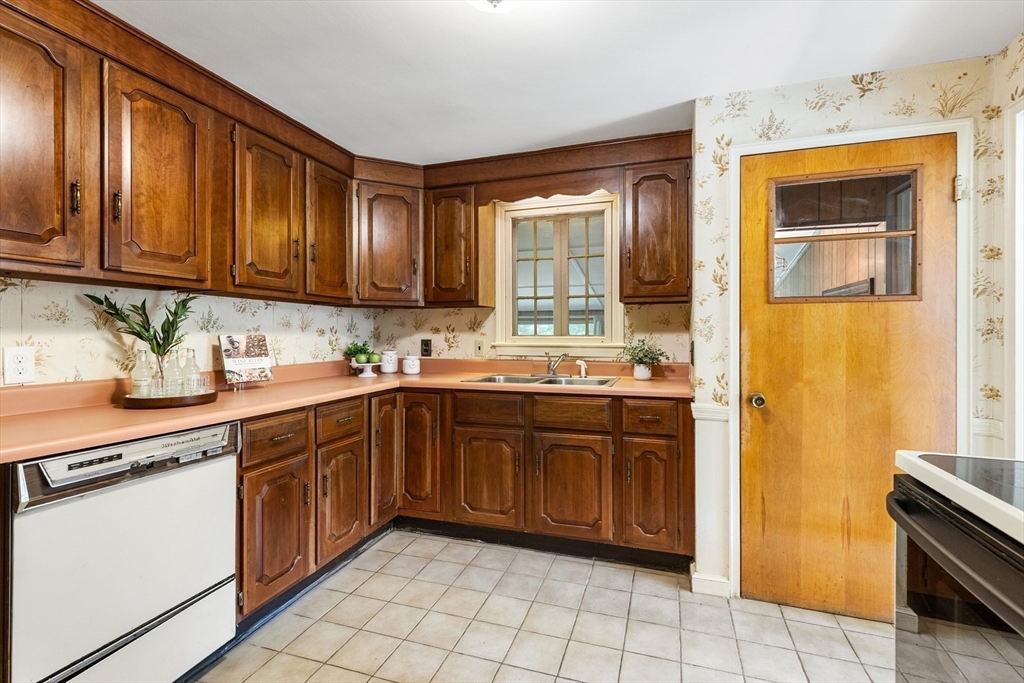 5 Gerry Road Lynnfield, MA 01940 - Photo 7 of 22 a kitchen with stainless steel appliances granite countertop a stove sink and cabinets