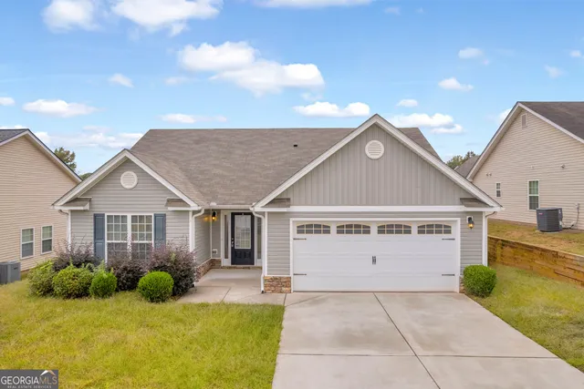 a front view of a house with yard and garage