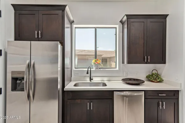 a kitchen with a sink and a refrigerator