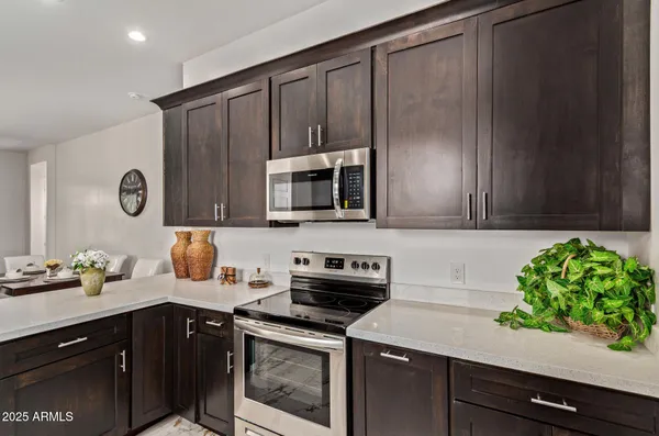 a kitchen with stainless steel appliances a stove microwave and sink