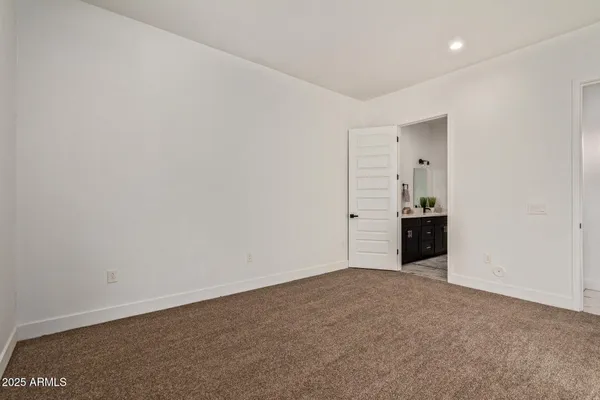 a view of an empty room with a kitchen