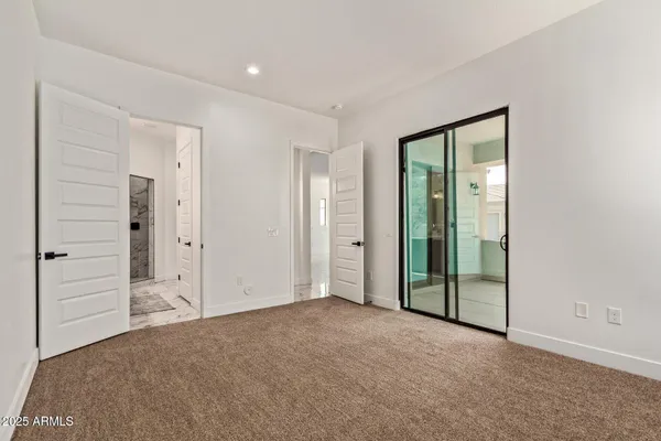 an empty room with closet and a bathroom