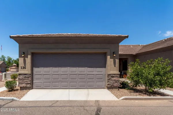 a front view of a house with garage