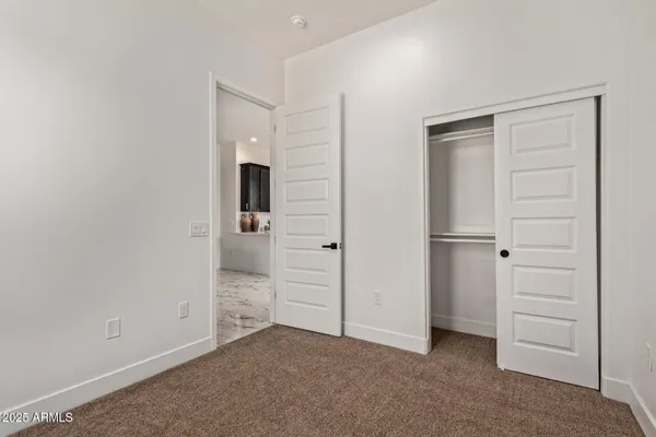 a view of an empty room and closet area