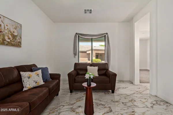 a living room with furniture a rug and a window
