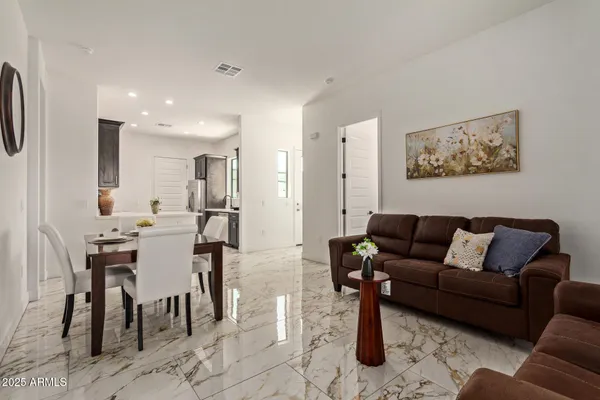 a living room with furniture kitchen view and a dining table