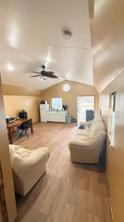 a living room with furniture and a chandelier