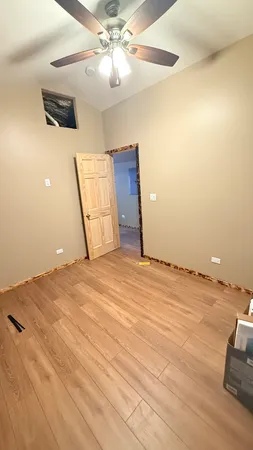 a view of a livingroom with a ceiling fan a ceiling fan and wooden floor
