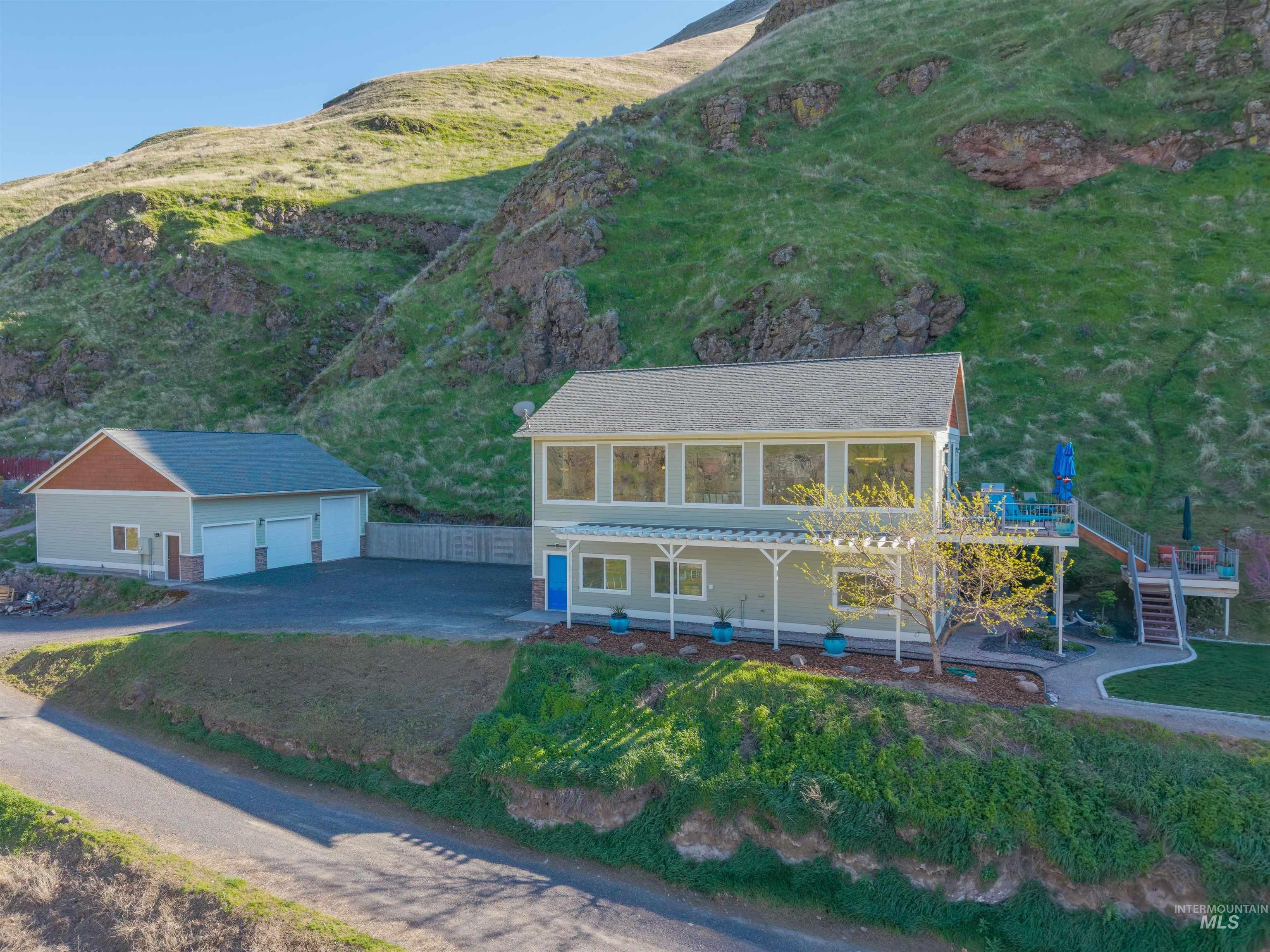 6382 Snake River Road Asotin, WA 99402 - Photo 1 of 34 View of front facade featuring an outbuilding, a garage, and a front lawn