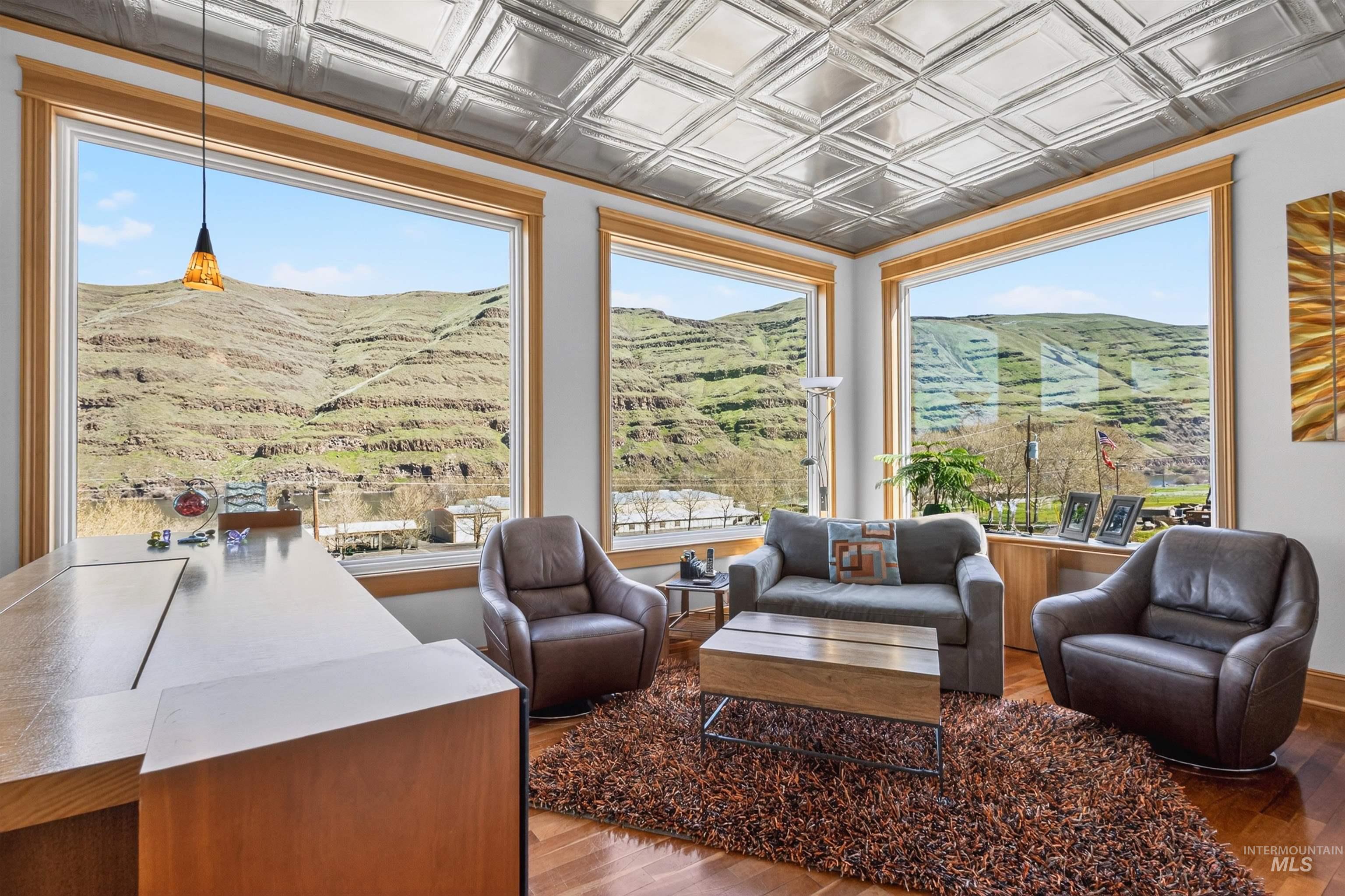 6382 Snake River Road Asotin, WA 99402 - Photo 17 of 34 Living room with a mountain view, an ornate ceiling, and hardwood / wood-style floors