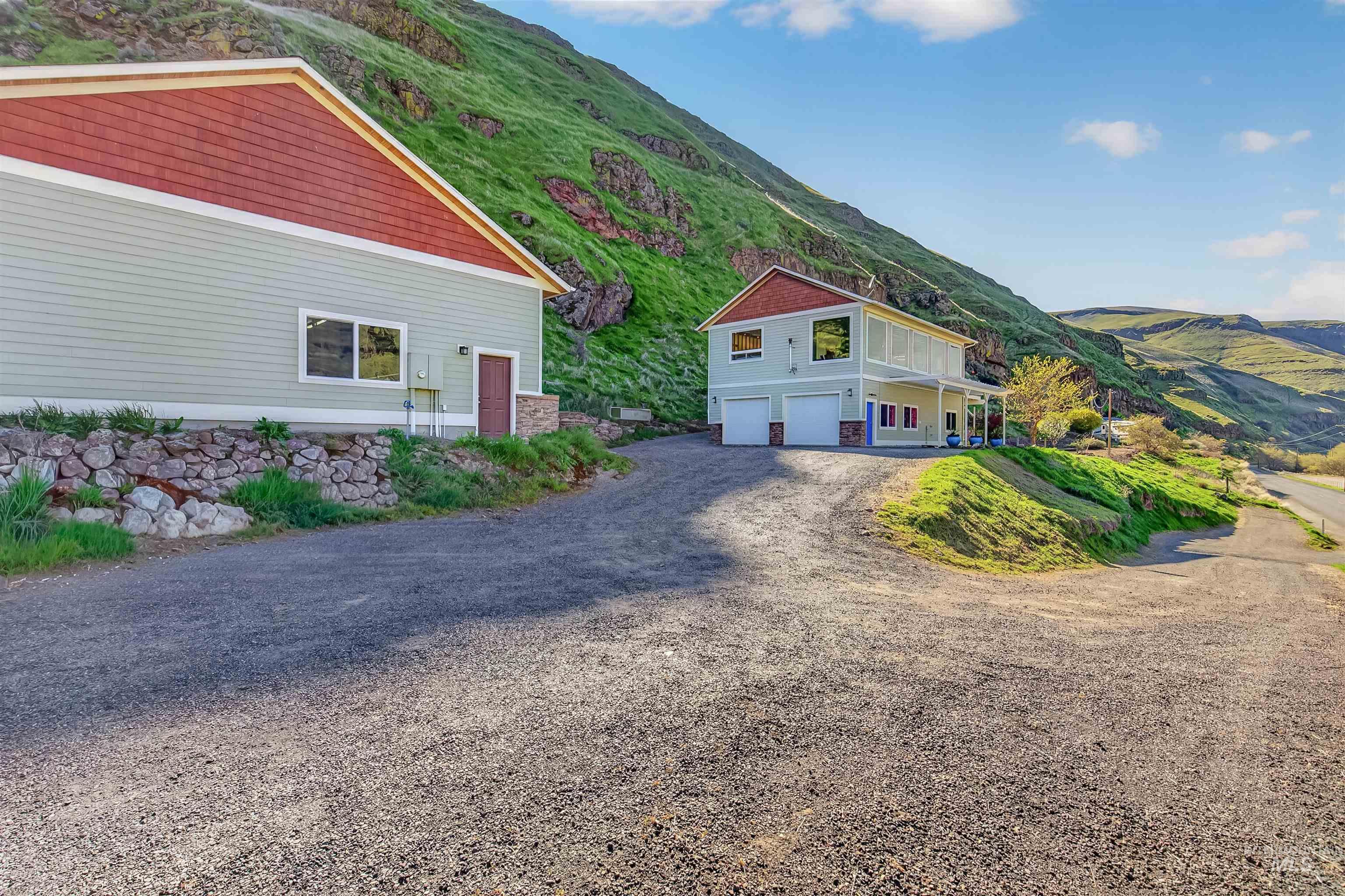 6382 Snake River Road Asotin, WA 99402 - Photo 2 of 34 View of side of home featuring a mountain view, driveway, and an attached garage