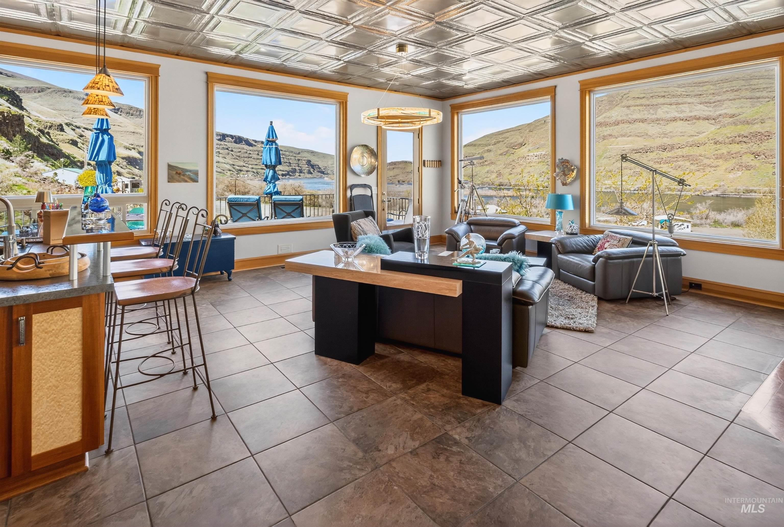 6382 Snake River Road Asotin, WA 99402 - Photo 4 of 34 Living room with an ornate ceiling, a mountain view, and dark tile patterned floors