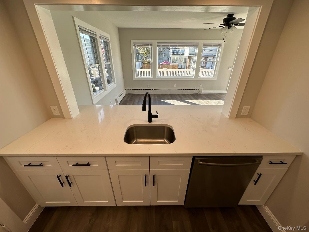 84 Rochester Avenue, Unit MAIN Long Beach, NY 11561 - Photo 11 of 27 a close view of a sink a washer and dryer