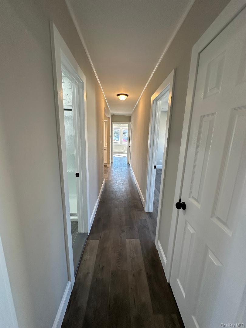 84 Rochester Avenue, Unit MAIN Long Beach, NY 11561 - Photo 15 of 27 a view of a hallway with wooden floor and staircase