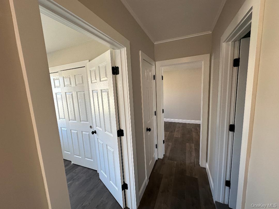 84 Rochester Avenue, Unit MAIN Long Beach, NY 11561 - Photo 16 of 27 a view of a hallway with wooden floor and staircase