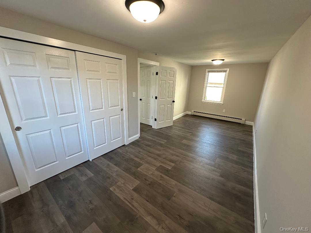 84 Rochester Avenue, Unit MAIN Long Beach, NY 11561 - Photo 18 of 27 a view of an empty room with window and closet area
