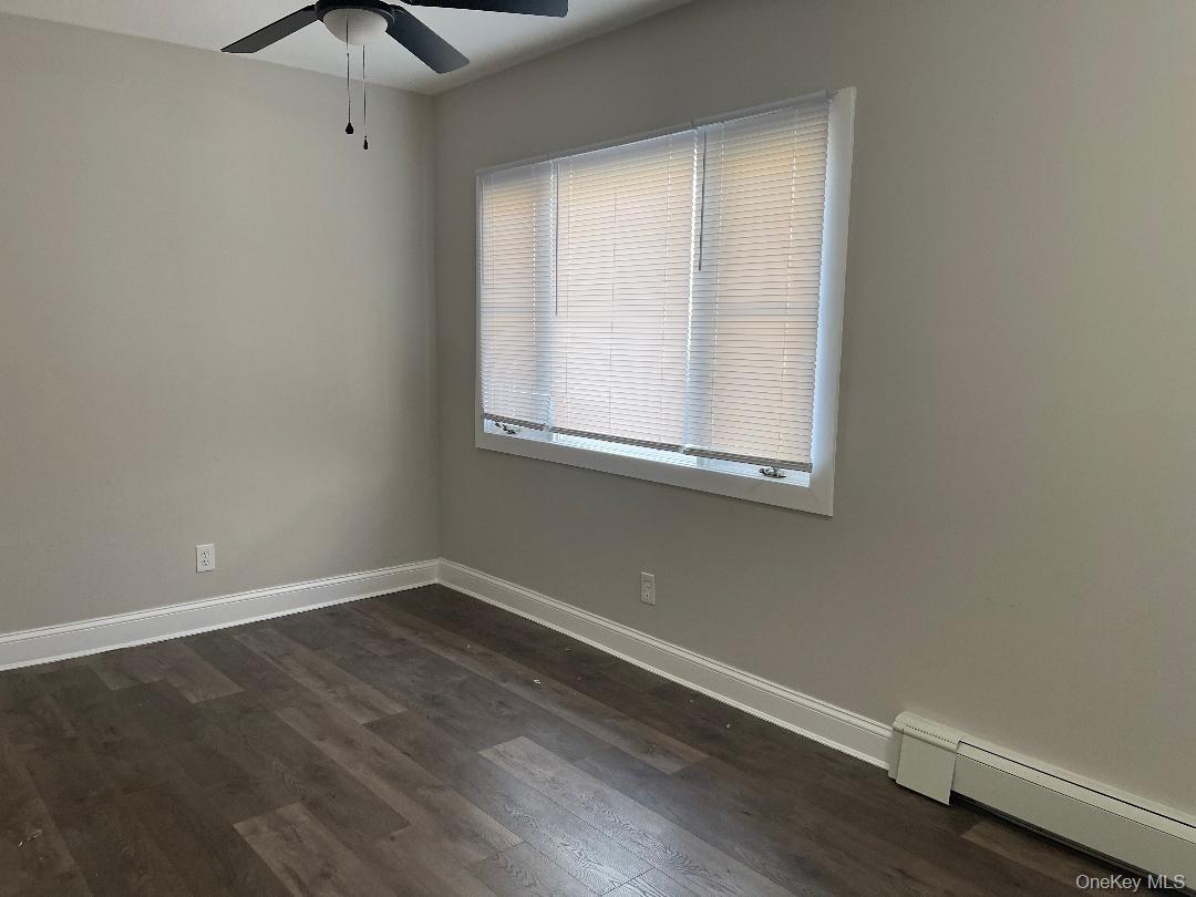 84 Rochester Avenue, Unit MAIN Long Beach, NY 11561 - Photo 22 of 27 an empty room with a window