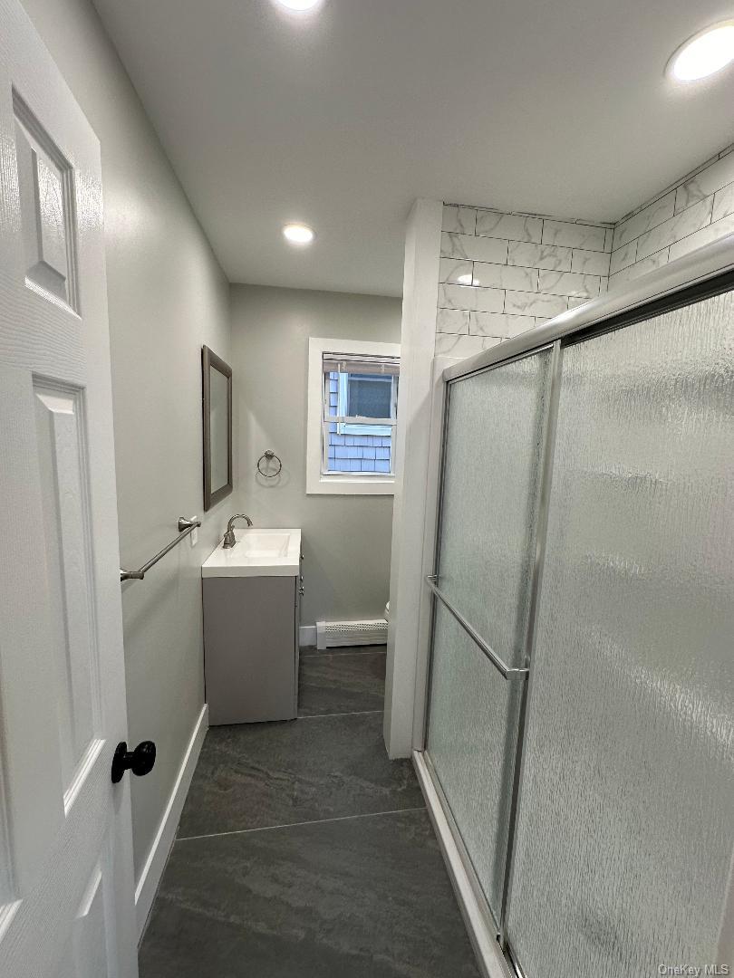 84 Rochester Avenue, Unit MAIN Long Beach, NY 11561 - Photo 23 of 27 a bathroom with a sink toilet and shower