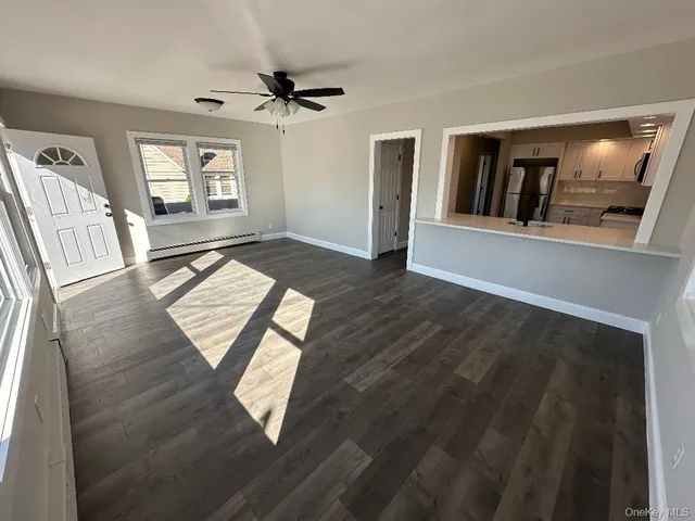 a view of an entryway with wooden floor
