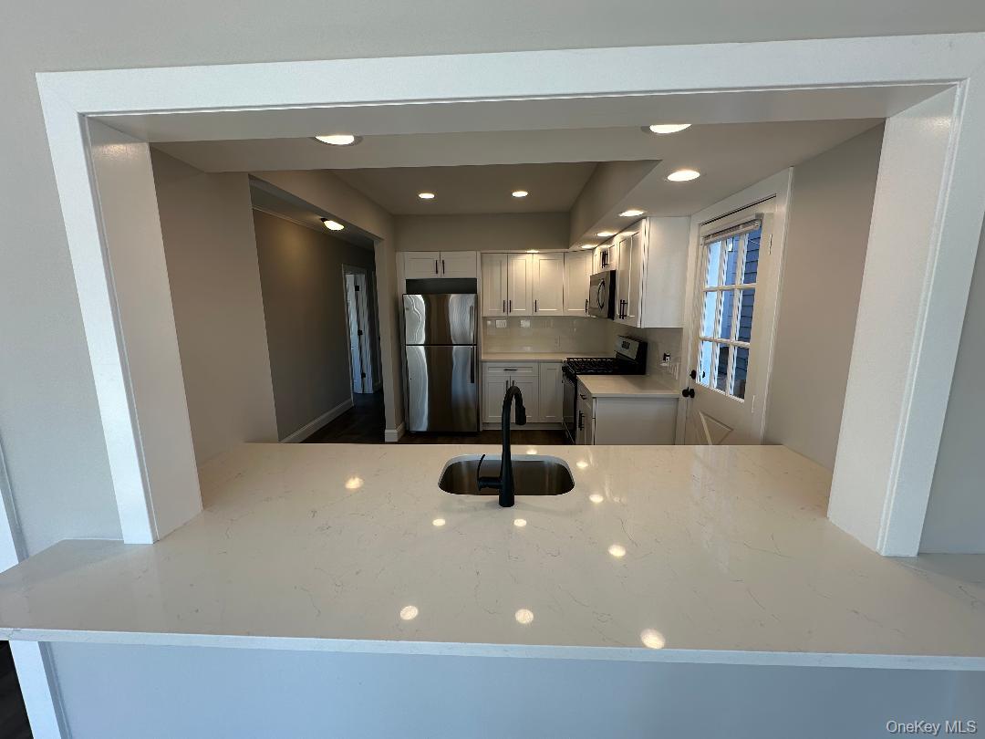 84 Rochester Avenue, Unit MAIN Long Beach, NY 11561 - Photo 8 of 27 a large room with kitchen view