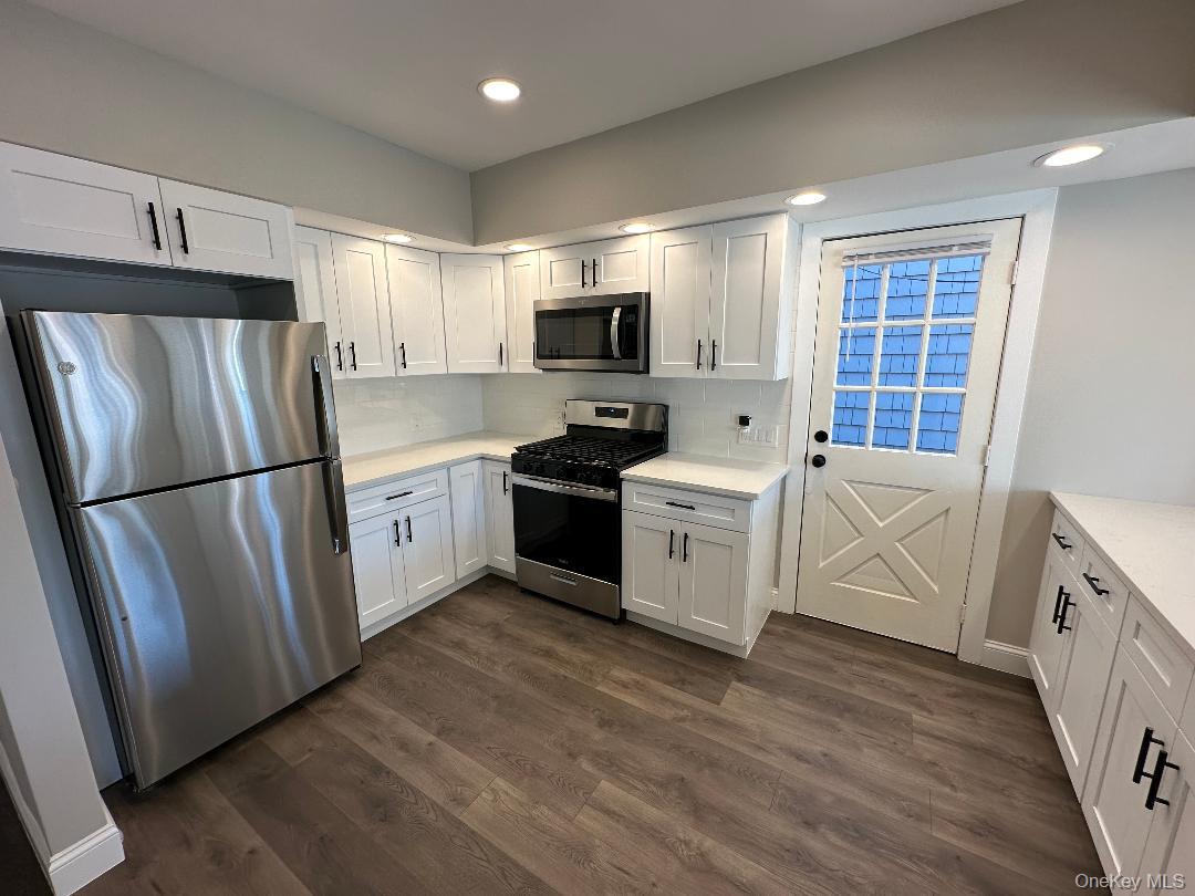 84 Rochester Avenue, Unit MAIN Long Beach, NY 11561 - Photo 10 of 27 a kitchen with stainless steel appliances a refrigerator sink and microwave