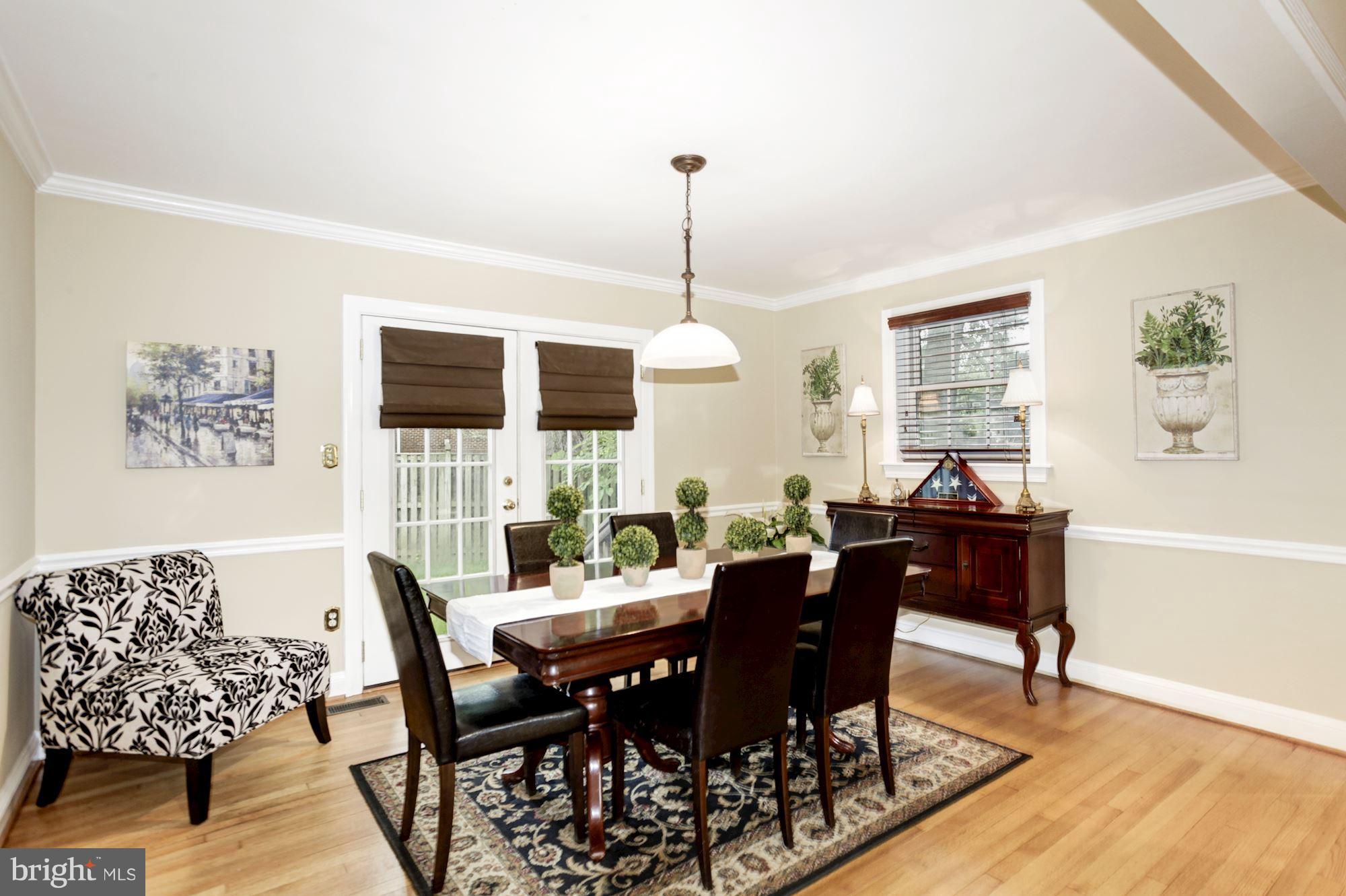 2819 South Arlington Ridge Road Arlington, VA 22202 - Photo 11 of 30 a dining room with furniture a rug and wooden floor
