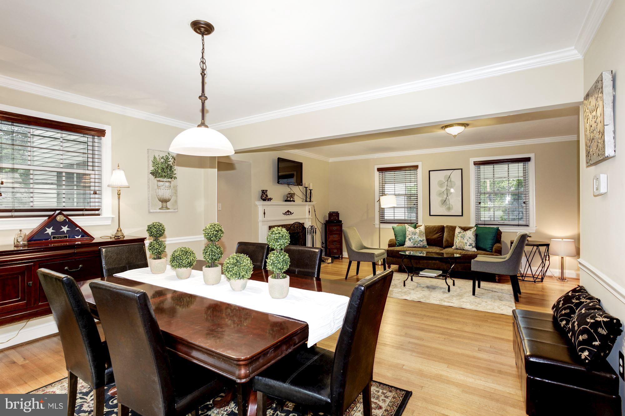2819 South Arlington Ridge Road Arlington, VA 22202 - Photo 13 of 30 a view of a dining room and livingroom with furniture wooden floor a chandelier