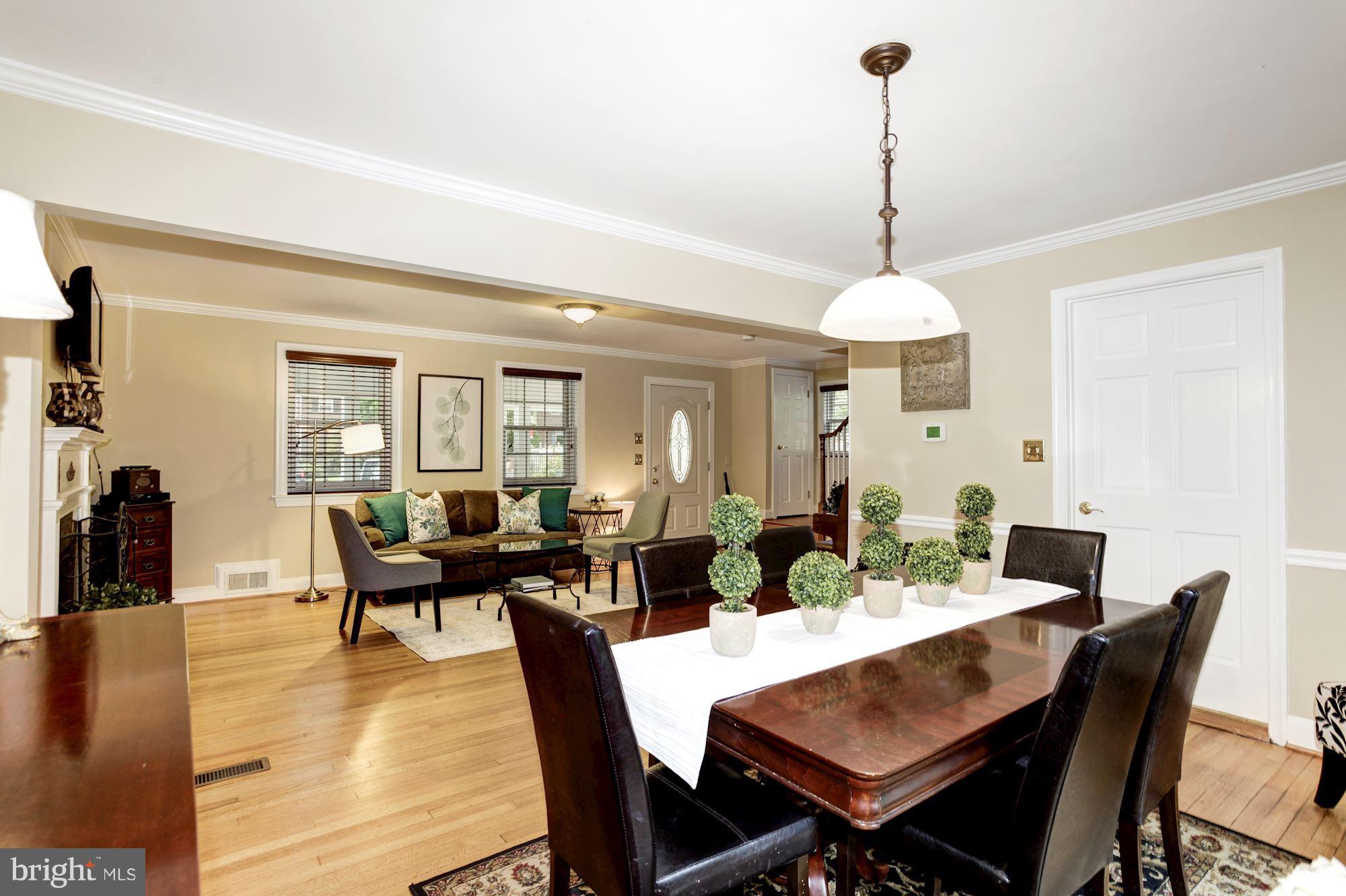 2819 South Arlington Ridge Road Arlington, VA 22202 - Photo 14 of 30 a view of a dining room and livingroom with furniture wooden floor a chandelier