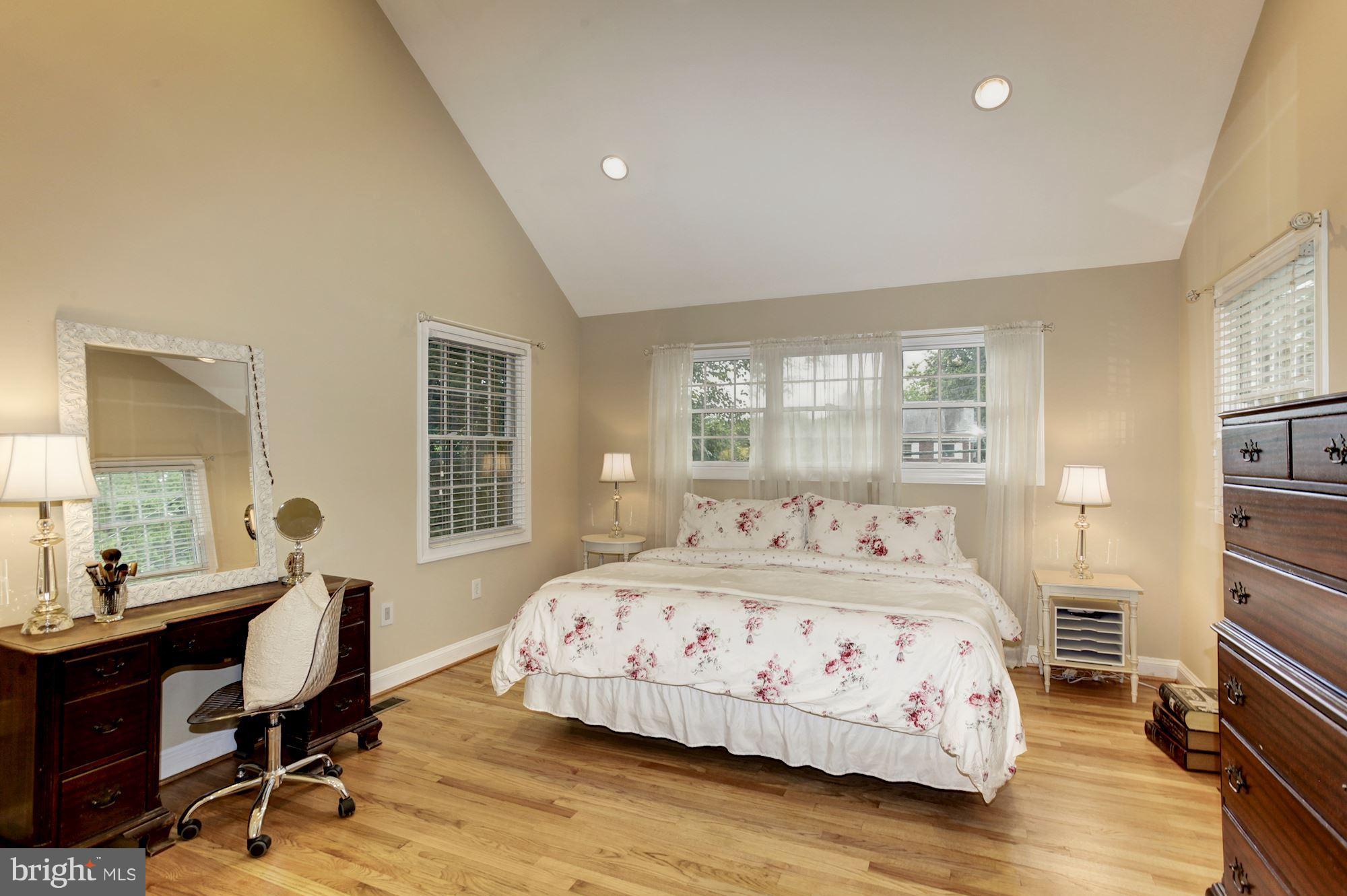 2819 South Arlington Ridge Road Arlington, VA 22202 - Photo 15 of 30 a bedroom with a bed a table and a dresser