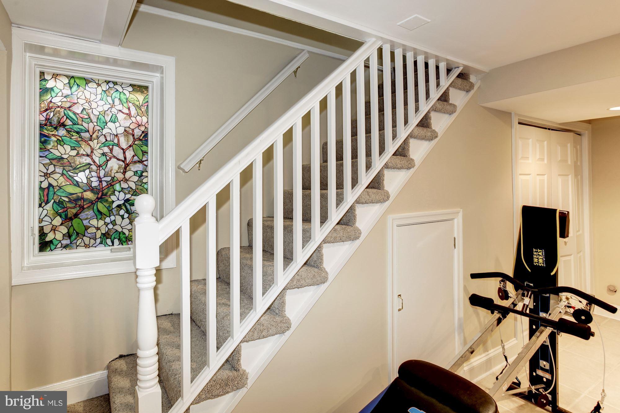 2819 South Arlington Ridge Road Arlington, VA 22202 - Photo 26 of 30 a view of staircase with wooden floor and a window