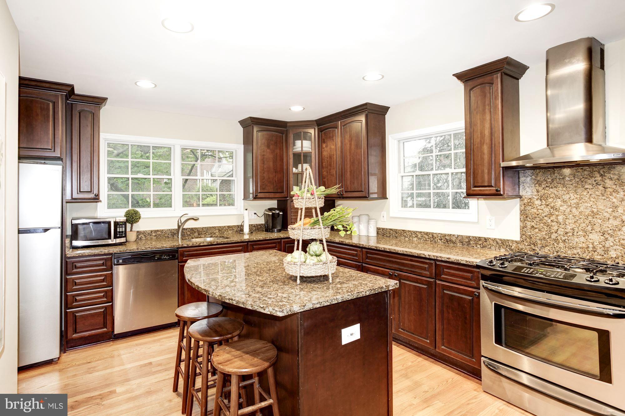 2819 South Arlington Ridge Road Arlington, VA 22202 - Photo 4 of 30 a kitchen with granite countertop a sink and a stove