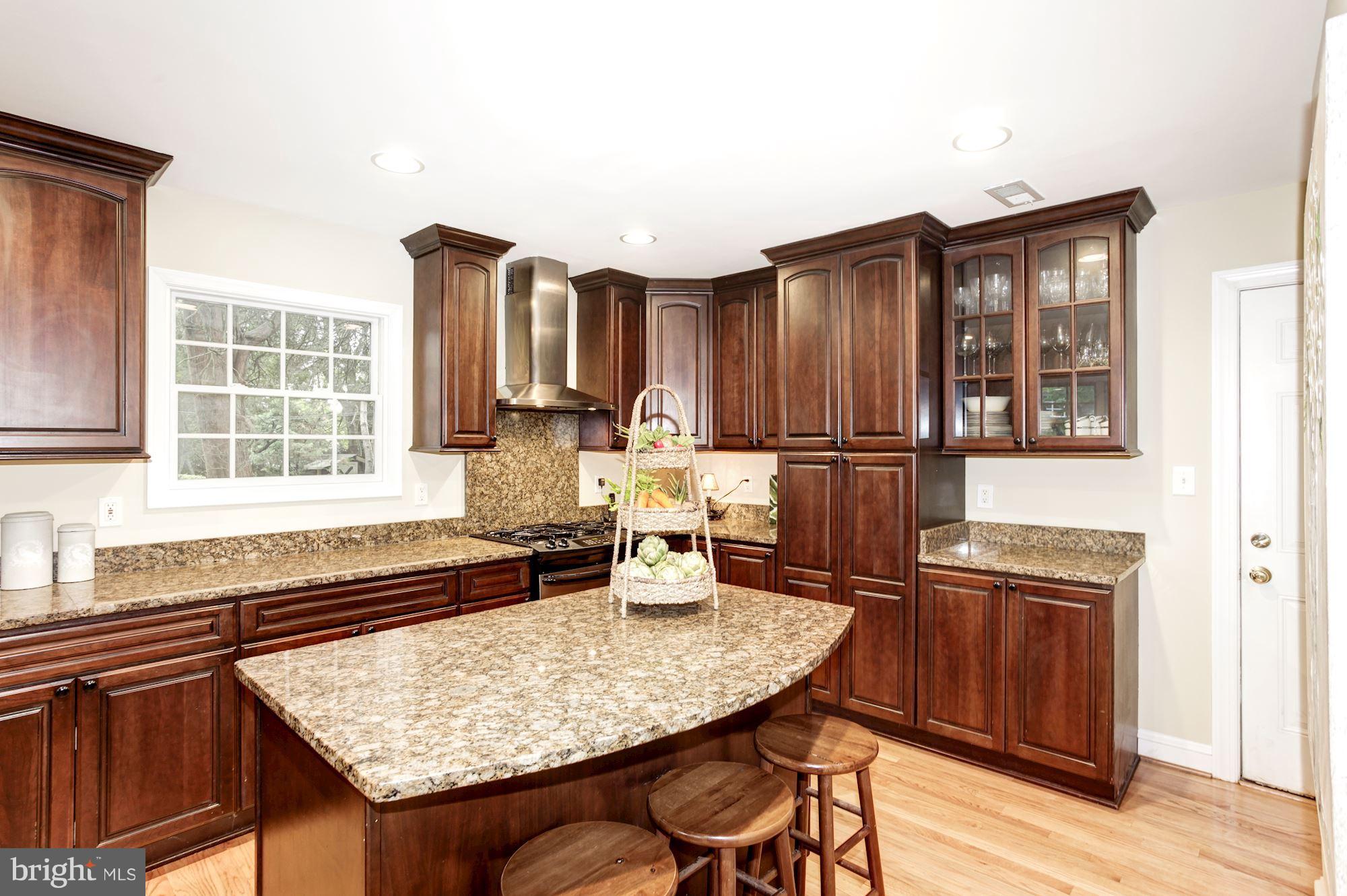 2819 South Arlington Ridge Road Arlington, VA 22202 - Photo 5 of 30 a kitchen with a sink refrigerator and wooden cabinets