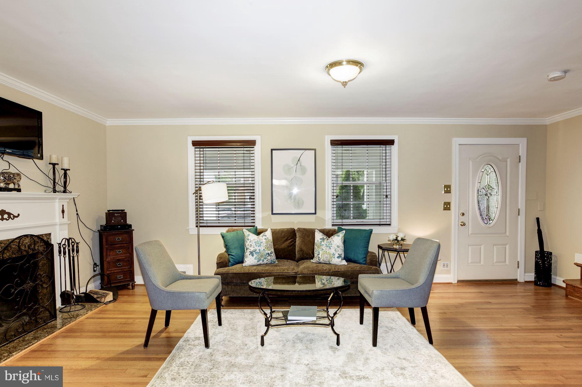 2819 South Arlington Ridge Road Arlington, VA 22202 - Photo 10 of 30 a living room with furniture a fireplace and a table