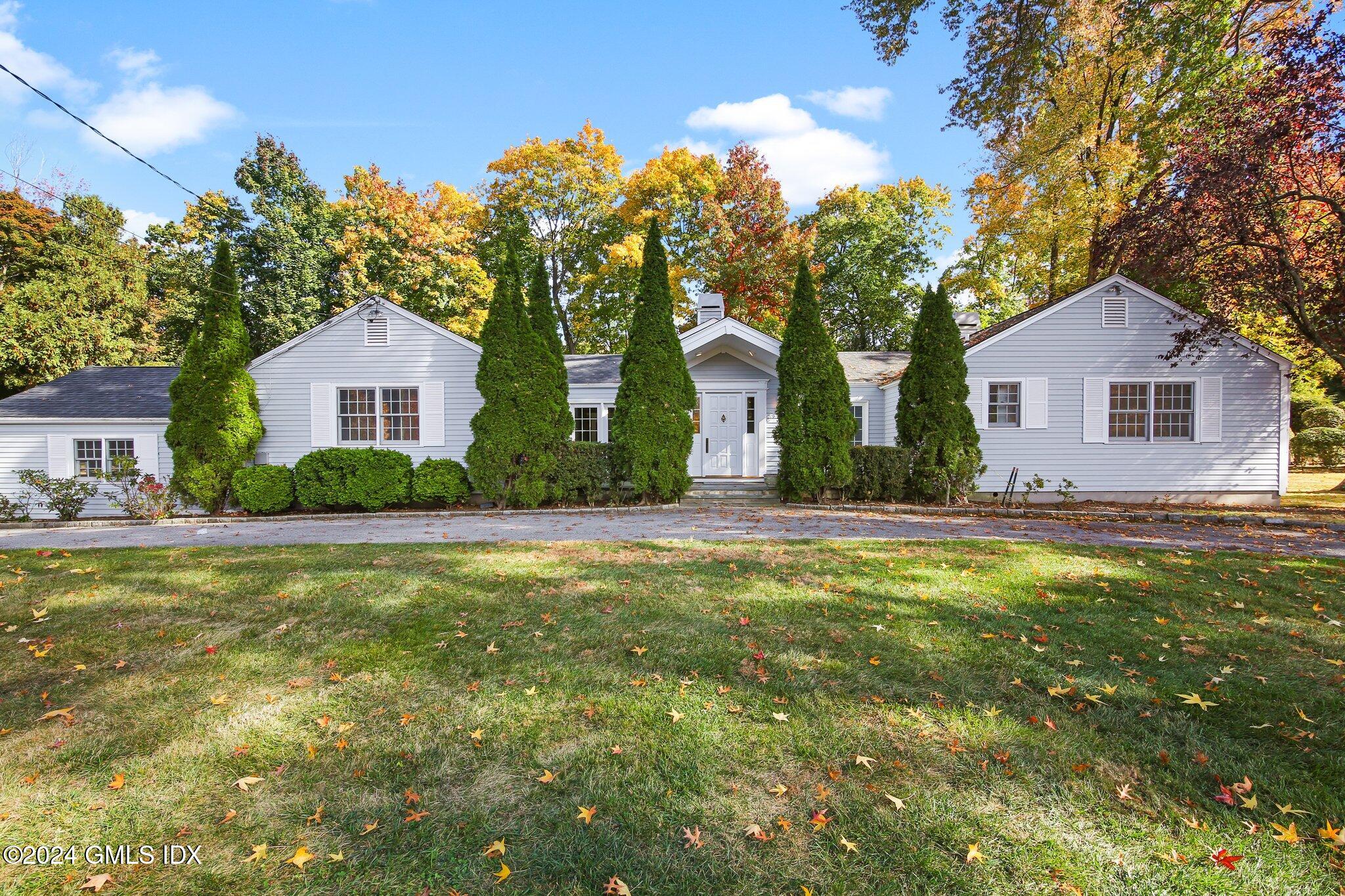 21 Dawn Harbor Lane Riverside, CT 06878 - Photo 1 of 1 a front view of house with yard and green space