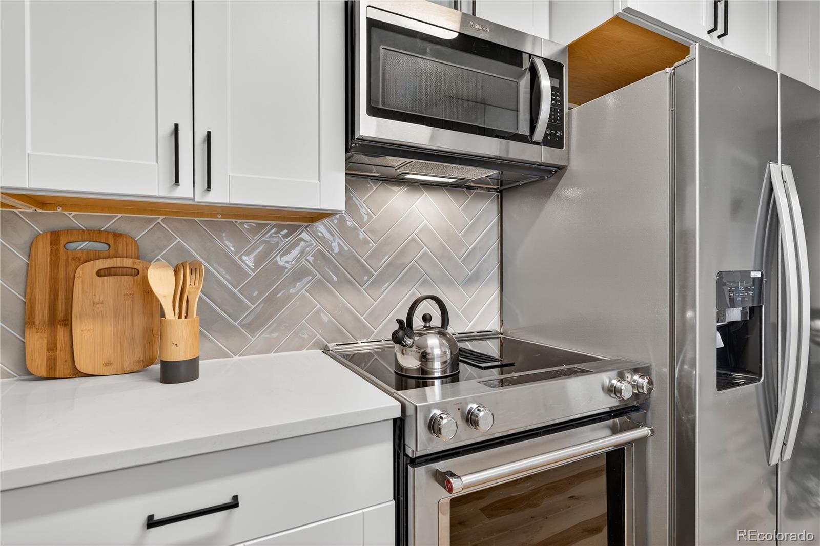 4910 East Missouri Avenue Denver, CO 80246 - Photo 15 of 42 a kitchen with a stove and a microwave