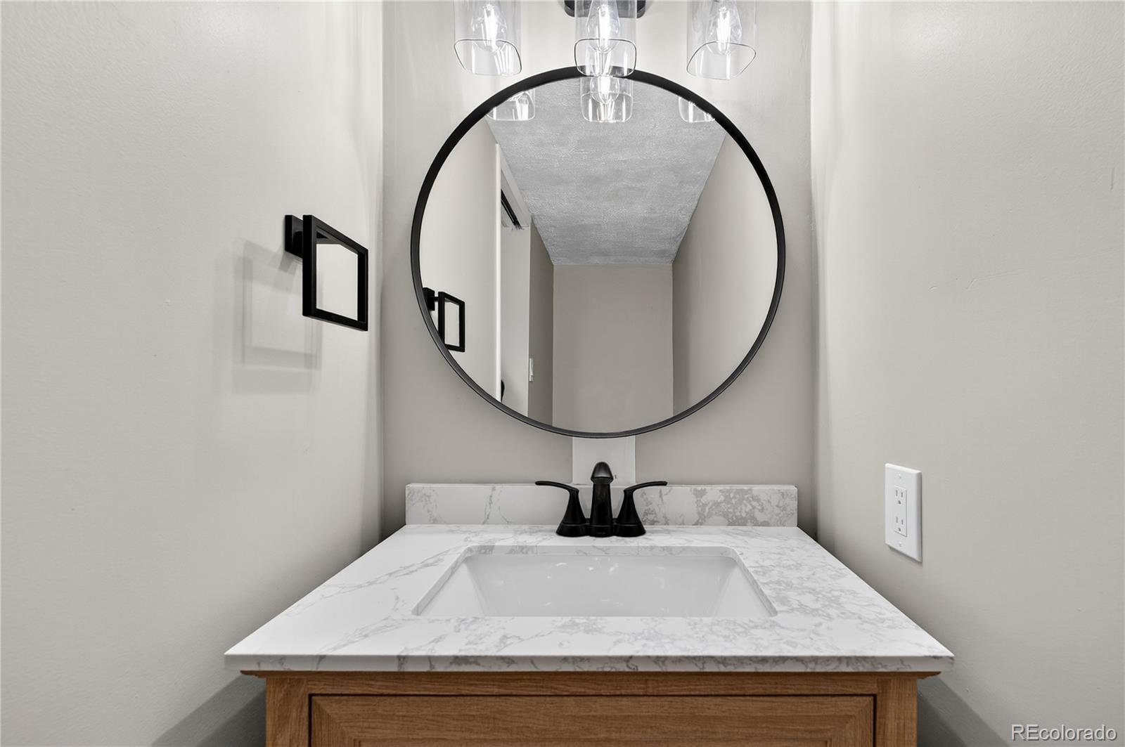 4910 East Missouri Avenue Denver, CO 80246 - Photo 19 of 42 a bathroom with a sink and a mirror