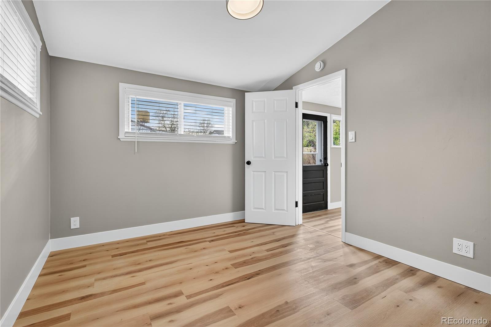 4910 East Missouri Avenue Denver, CO 80246 - Photo 20 of 42 an empty room with wooden floor and windows