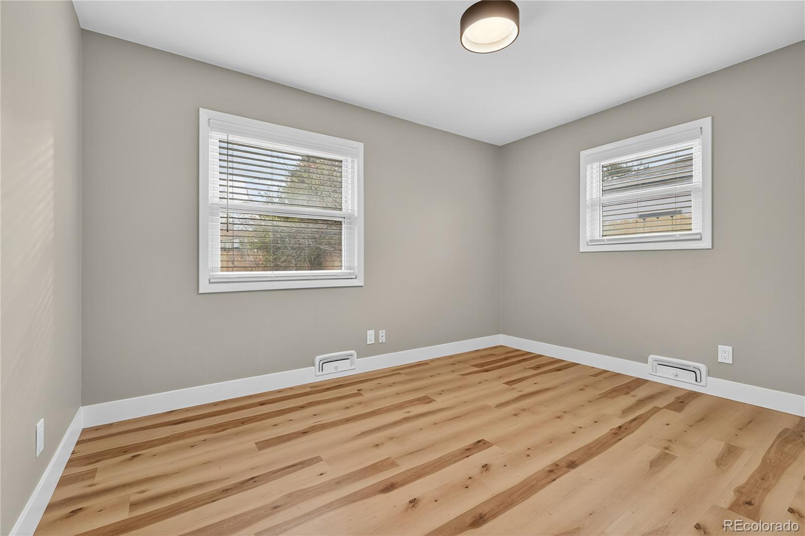 4910 East Missouri Avenue Denver, CO 80246 - Photo 22 of 42 a view of a bedroom with wooden floor and window